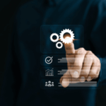 A man points toward an icon of interconnected gears